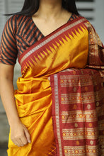 Load image into Gallery viewer, Woman wearing a yellow sambalpuri pata saree with a maroon and gold border