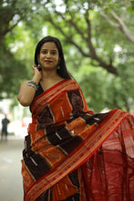 Load image into Gallery viewer, Elegant orange-black Sambalpuri saree showcasing floral Ikat motifs and traditional weaving – Pasapali