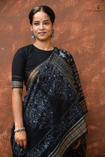 Load image into Gallery viewer, Krishnakali black Sambalpuri Bandha mercerized cotton saree by Pasapali — full hero view with aambo kasi pallu and fish border