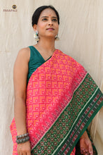 Load image into Gallery viewer, Mangala Pink Sambalpuri cotton saree draped at front — Bandha double ikat weave with green accents by Pasapali