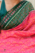 Load image into Gallery viewer, Mangala Pink and Green Sambalpuri Bandha cotton saree folded — showing pallu fish motifs and Rudraksha border