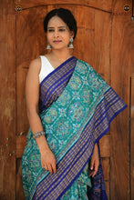 Load image into Gallery viewer, Body weave detail of Neelambari — flower motifs in teal green Sambalpuri Bandha cotton saree, warp-weft ikat alignment