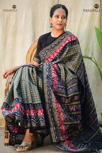 Load image into Gallery viewer, Front drape of Pasarekha Grey Sambalpuri Bandha mercerized cotton saree showing pleat structure and border detail