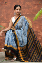 Load image into Gallery viewer, Smritirekha Sambalpuri Bandha pallu close-up — flower and fish motif in gold on light blue mercerized cotton