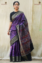 Load image into Gallery viewer, Vasundhara Sambalpuri cotton saree folded to show purple body, fish border, and black pallu contrast. Pasapali.