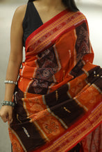 Load image into Gallery viewer, Orange and black Sambalpuri cotton saree with floral Ikat motifs and elegant red pallu – Pasapali
