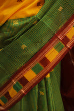 Load image into Gallery viewer, Heritage-inspired half-half design saree in yellow and mehendi hues, made from pure cotton

