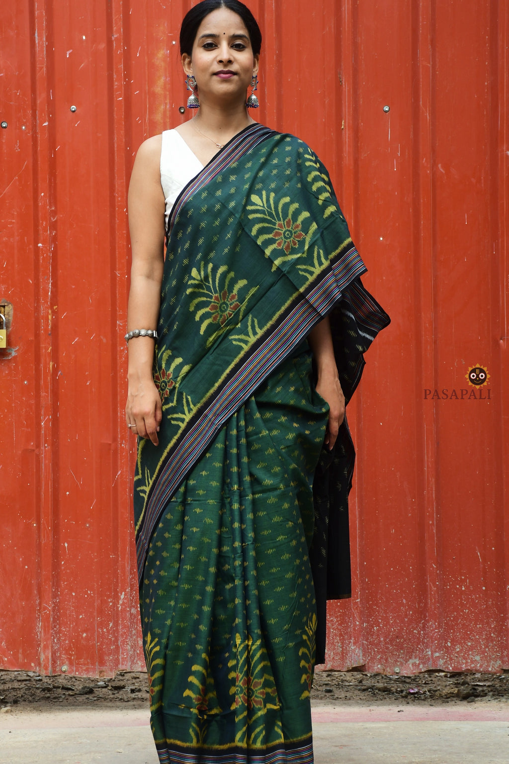 Close-up of multicoloured striped ikat border on deep green Sambalpuri mercerized cotton saree by Pasapali.
