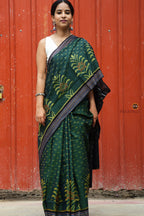 Close-up of multicoloured striped ikat border on deep green Sambalpuri mercerized cotton saree by Pasapali.