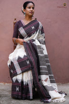 Aalraga Off-White Kotpad saree folded view — earthy brown kumbha border and tribal motifs, Mirgan weavers Odisha