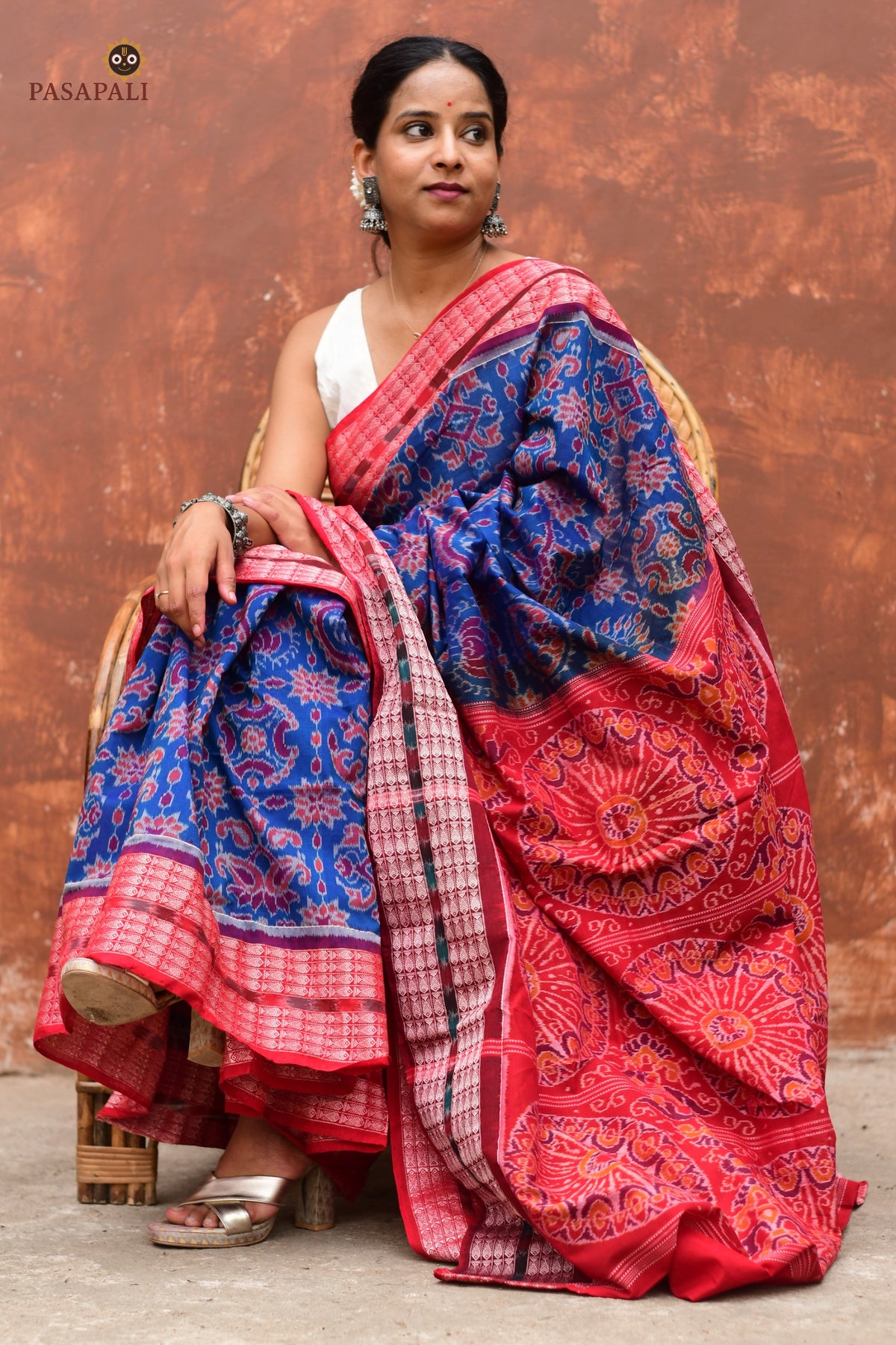 Akshaya Blue Sambalpuri cotton saree draped front view showing flower chakra body motif and red contrast border