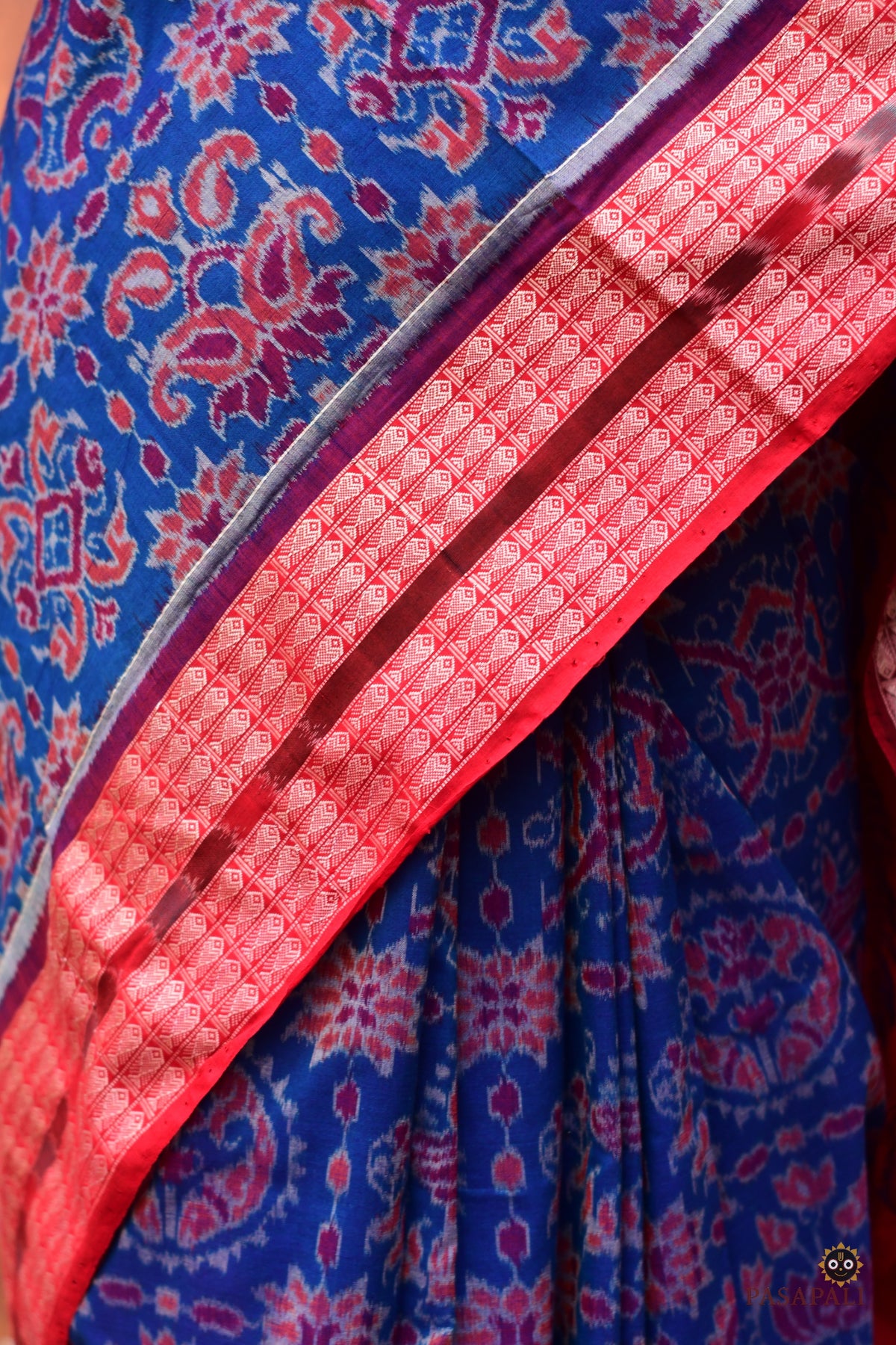 Motif detail of Akshaya — flower chakra and jhoti ikat patterns across blue body of Sambalpuri Bandha cotton saree