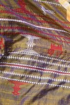 Flat lay of Amalaki golden Kotpad Tussar Cotton Silk saree — red kumbha border, tribal body motifs, Pasapali