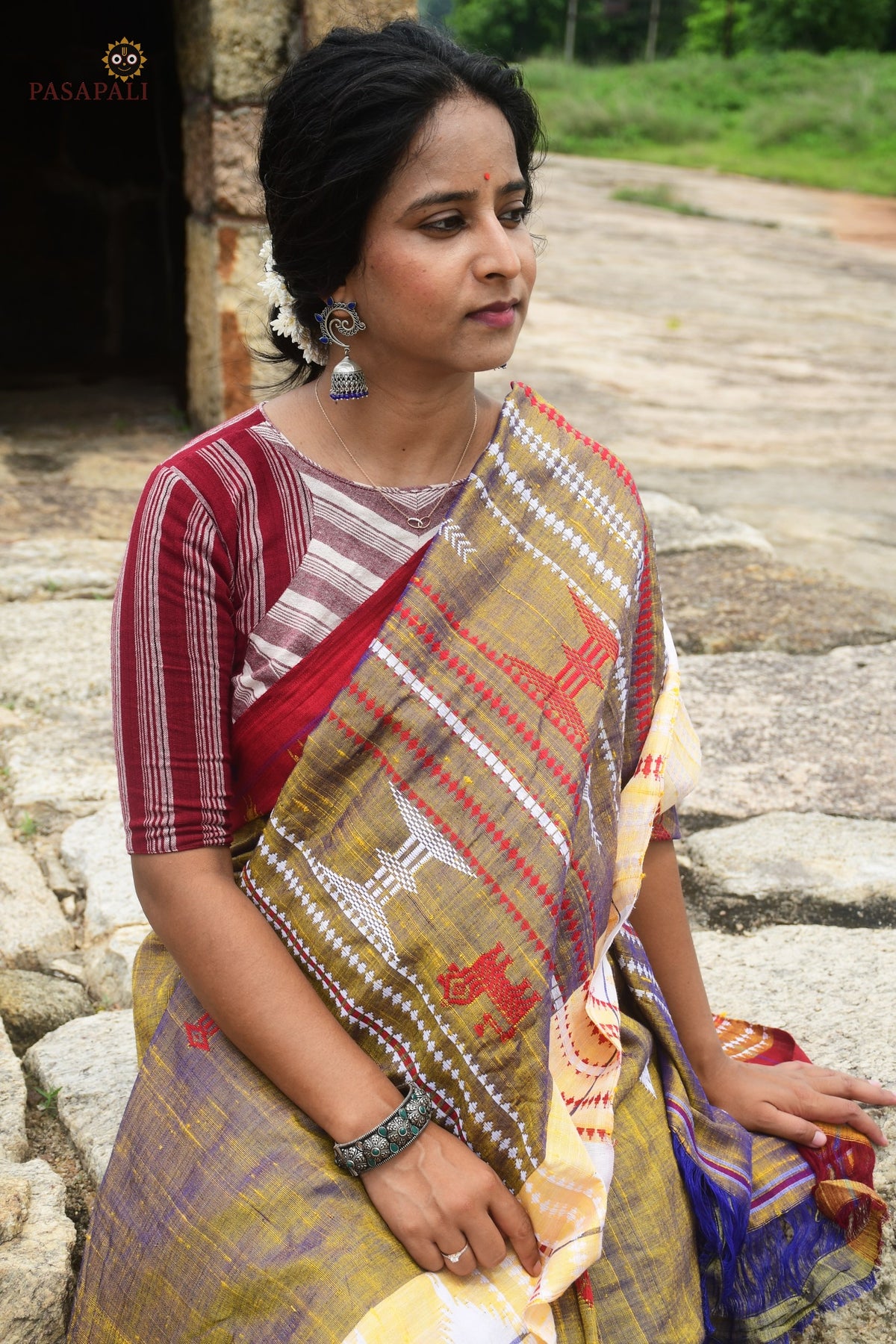 Amalaki Kotpad handloom saree front drape — golden body with red macha and pharsa motifs, Odisha vegetable dye