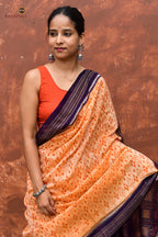 Anasuya Bandha ikat saree by Pasapali — folded saree showing Apricot Beige ground, Blue border and pallu.