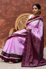 Load image into Gallery viewer, Folded flat view of Annapurna pink Sambalpuri Bandha saree showing GI certified handloom weave and deep maroon border, Pasapali.
