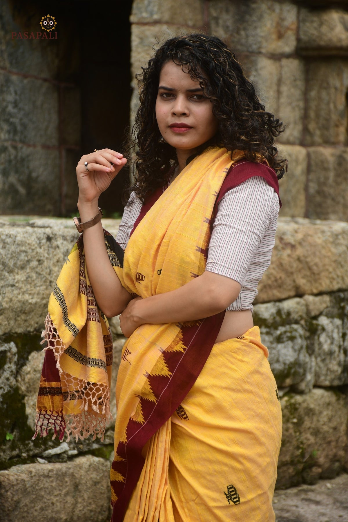 Arunima Kotpad saree pallu detail — macha fish and pharsa axe tribal motifs in extra-weft technique, yellow ground