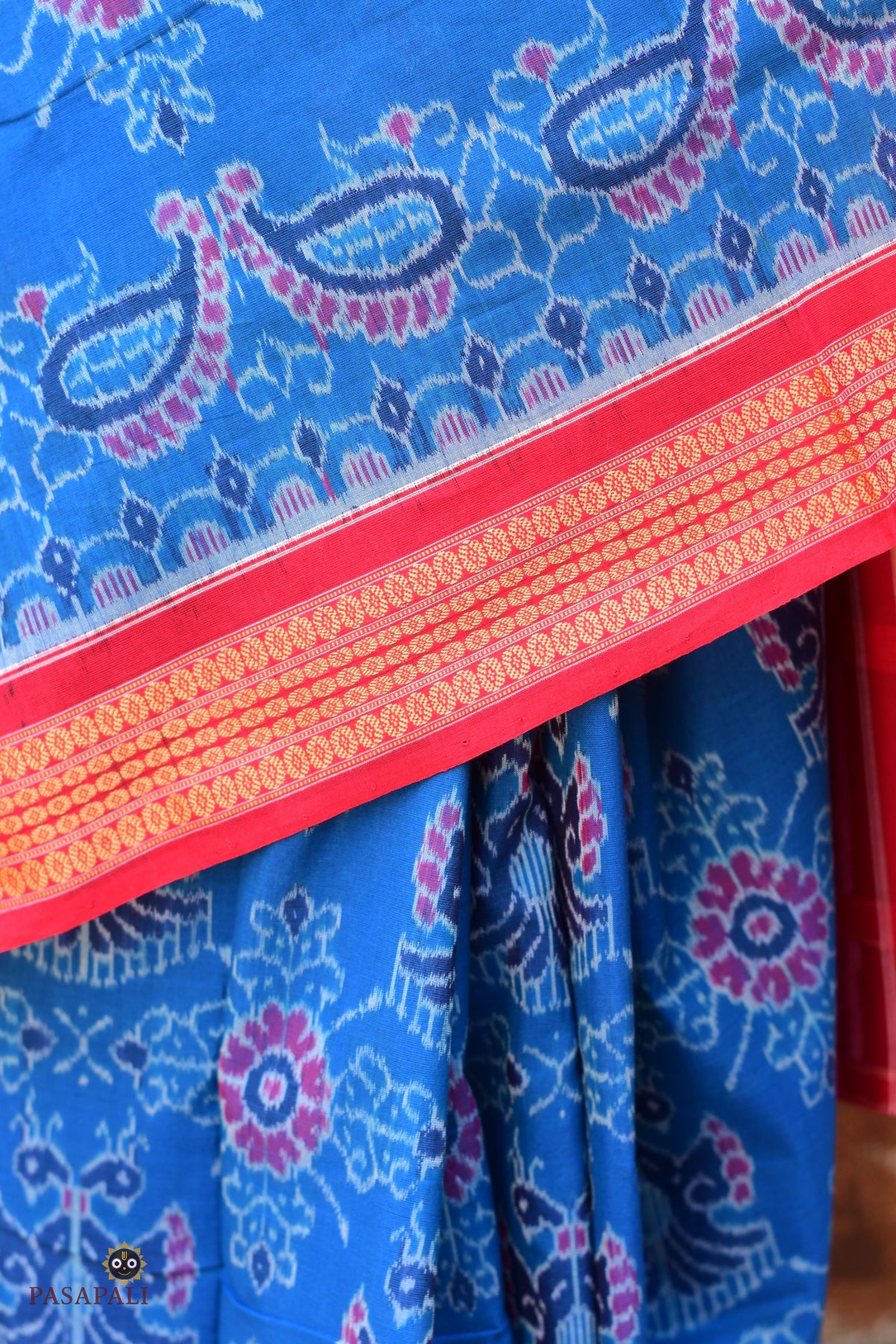 Flat lay of Barshika Blue Sambalpuri Bandha mercerized cotton saree — full length view showing body, border, pallu Pasapali