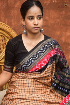 Flat lay of Basundhara Sambalpuri cotton saree — full length showing check body, kumbha fish border and floral pallu, Pasapali
