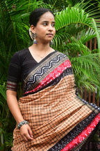 Basundhara Sambalpuri cotton saree folded flat — light brown with black border, GI certified Sambalpuri handloom by Pasapali