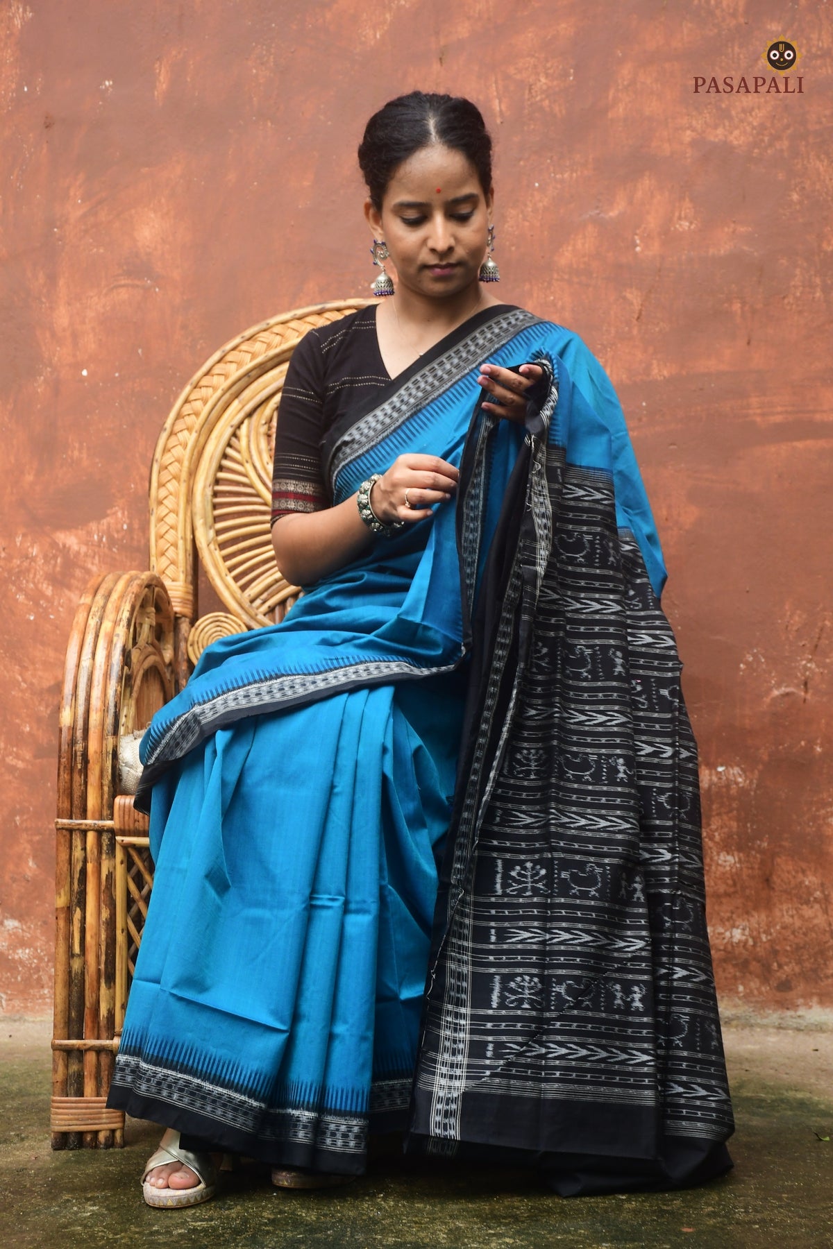 Flat lay of Bimala Sambalpuri cotton saree — blue body, ikat kathiphera border, duck and tree pallu, Pasapali