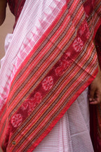 Charushila folded and stacked — white red Sambalpuri cotton Sachipar saree, dasphulia border visible, Pasapali