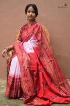 Charushila Sachipar saree front drape — white mercerized cotton, red border, Sambalpuri Bandha weave by Pasapali