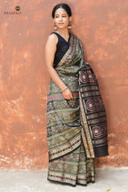 Flat lay of Chitrangada grey Sambalpuri Bandha mercerized cotton saree — fish border, tribal body, phula chakra pallu, Pasapali
