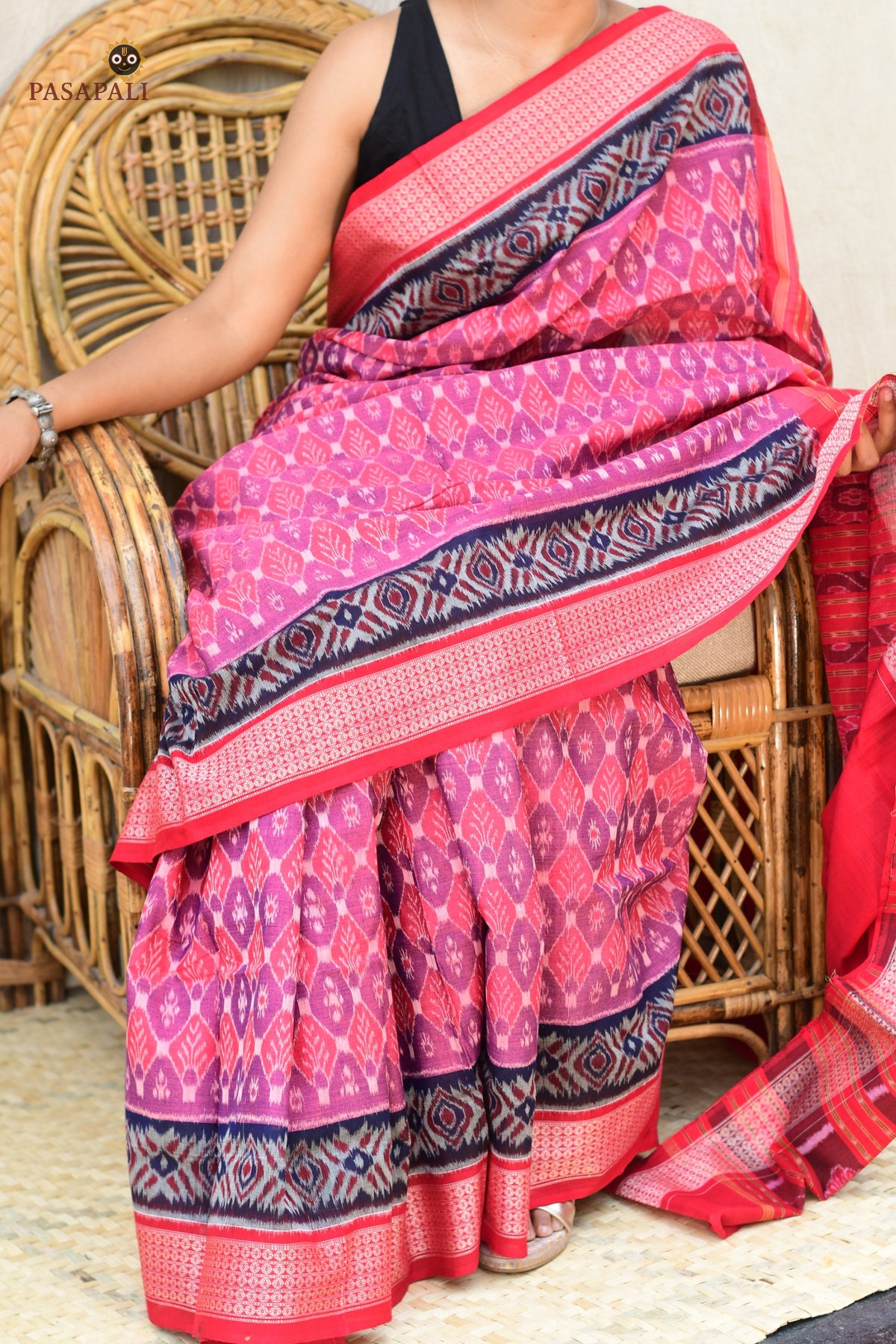 Flat lay of Damayanti pink Sambalpuri mercerized cotton saree showing full body, border and pallu — Pasapali