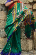 Close-up of kumbha border on Deomali green Kotpad saree — raised temple motif, multi-shuttle interlocking technique