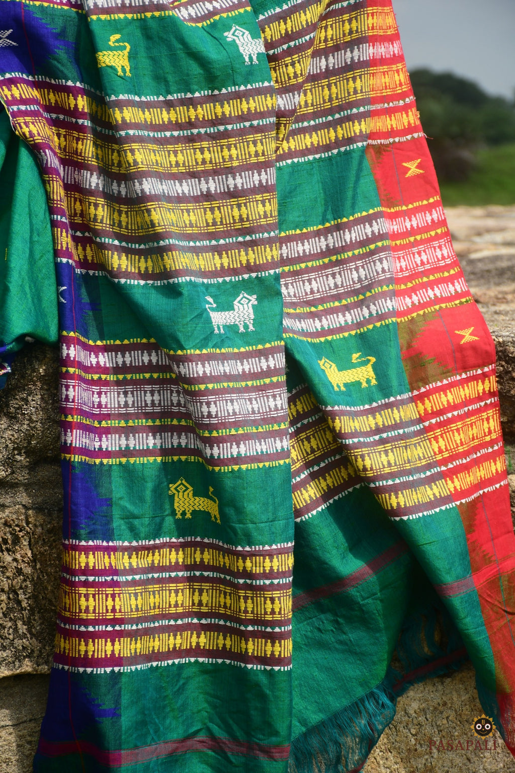Deomali Kotpad natural dye saree folded view — green with blue and red accents, GI certified, Pasapali
