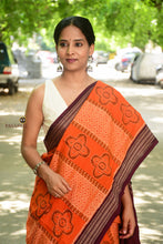 Load image into Gallery viewer, Folded view of orange Sambalpuri mercerized cotton saree with deep maroon Phula and Rudraksha motifs, Pasapali.
