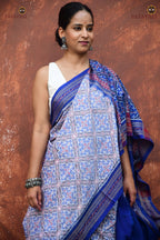 Indulekha Sambalpuri Bandha saree front drape — white body, blue flower patterns, Rudraksha border, Pasapali