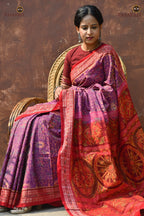 Flat lay of Janapadi Sambalpuri cotton saree — purple body, red accents, fish border, Plula pallu. Pasapali.