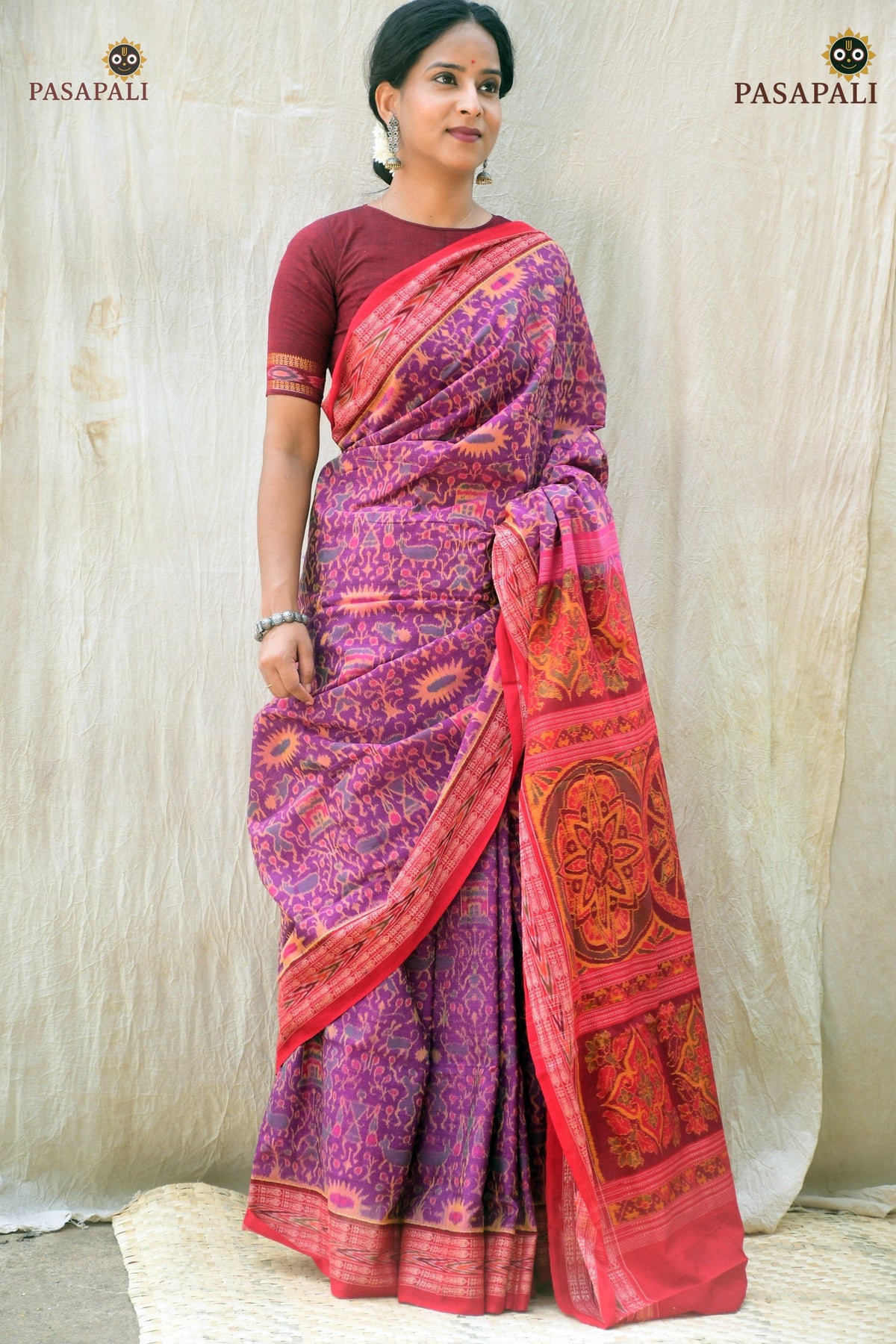 Janapadi pallu detail — Plula flower and Konark Chakra in Bandha double ikat on purple mercerized cotton. Pasapali.