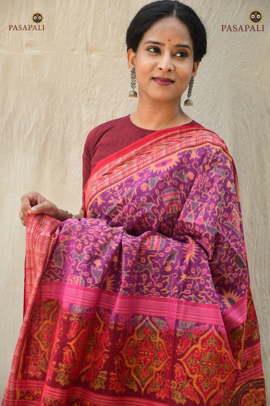 Janapadi purple Sambalpuri cotton saree folded view — fish border and red secondary colour visible. Pasapali.
