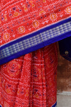 Kalapini Sambalpuri Bandha mercerized cotton saree in orange and blue — overall hero flat view, Pasapali