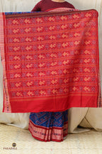 Drape front of Kaumudi GI certified Sambalpuri Bandha saree in mercerized cotton — chevron ikat body in deep blue