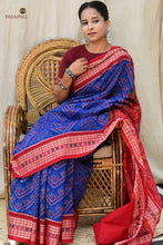 Load image into Gallery viewer, Front drape of Kaumudi Blue Sambalpuri Bandha saree showing double ikat chevron pattern and red border detail

