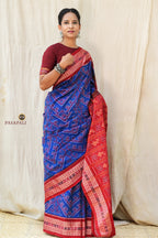 Pallu close-up of Kaumudi Sambalpuri Bandha saree featuring hand-dyed fish and flower ikat motifs in blue and red