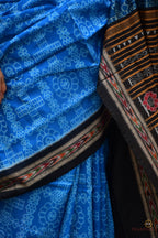 Overall flat lay of Kaushalya — Blue and Black Sambalpuri Bandha mercerized cotton saree with full border and pallu, Pasapali