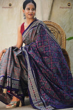 Load image into Gallery viewer, Kusumalata front drape close-up — Sambalpuri Bandha double ikat saree in mercerized cotton, grey with rust and blue palette
