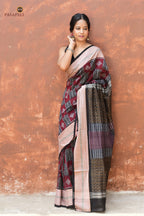 Lopamudra — close-up of chevron motif broad black border on maroon Sambalpuri Bandha cotton saree, Pasapali