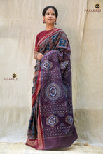 Load image into Gallery viewer, Folded flat view of Madhavi Brown Sambalpuri Bandha cotton saree with Rudraksha border visible — Pasapali
