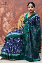 Mandakranta blue Sambalpuri Bandha mercerized cotton saree by Pasapali — full hero view with chevron body and green border
