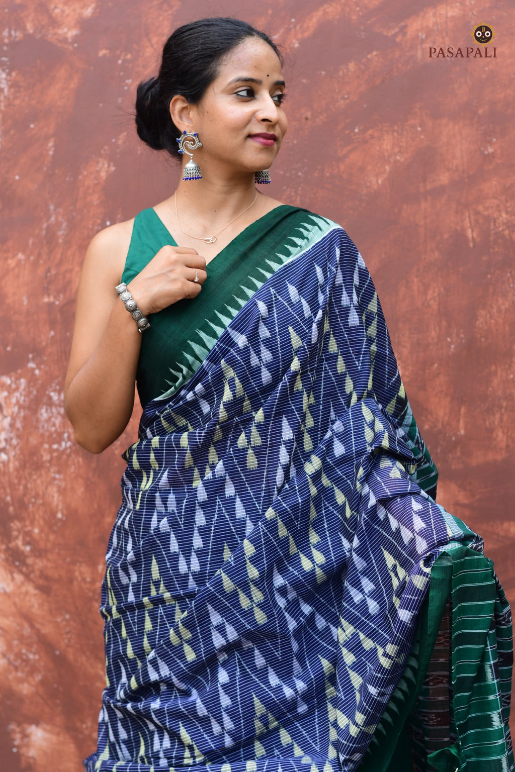 Flat lay of Mandakranta blue and green Sambalpuri Bandha mercerized cotton saree showing full length by Pasapali