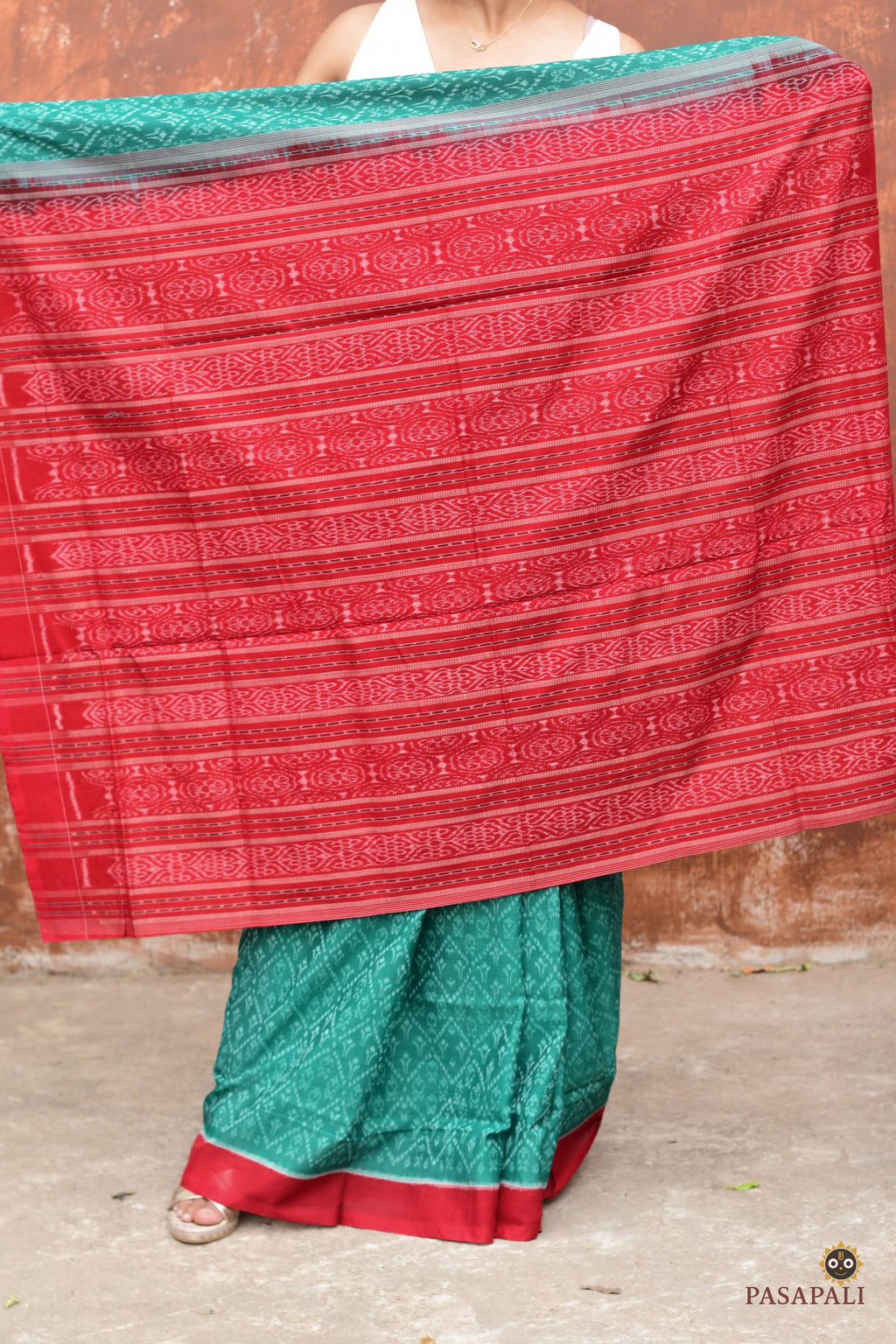 Mrinmayee green Sambalpuri cotton saree folded view — red border and Bandha ikat weave, Pasapali
