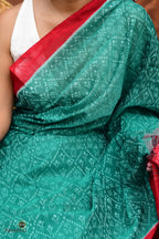 Handloom drape view of Mrinmayee Sambalpuri Bandha saree in green and red mercerized cotton by Pasapali