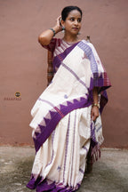 Nirjhari Kotpad Cotton saree front drape — off-white ground with purple kumbha border, Mirgan tribal weave, Pasapali