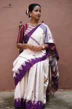 Close-up of kumbha border on Nirjhari Kotpad saree — raised temple motif, multi-shuttle interlocking, off-white cotton